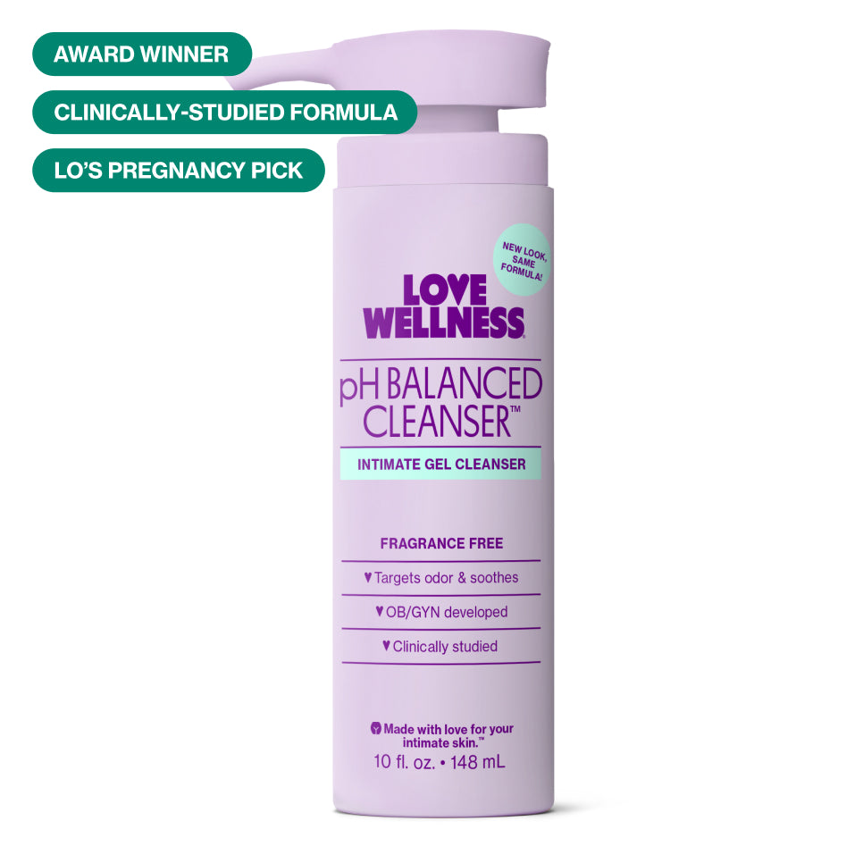 Love Wellness pH Balanced Cleanser, 10oz (148ml) packaging. Package is a light purple, cylinder with pump and spout at the top.
There is also a cyan circle at the top right which states "New Look, Same Formula", positioned near the logo.
There are also three green pills in the top left, which state "Award Winner", "Clincally-Studied Formula" and "Lo's Pregnancy Pick".