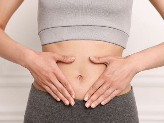 Woman holding hands over her stomach for good digestion
