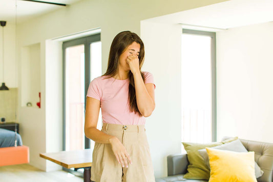 Woman covering nose because farts smell bad