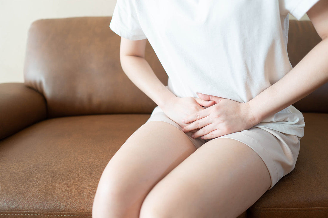 Woman experiencing vaginal odor discomfort at home